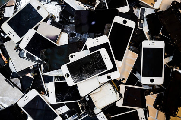 Broken smartphones ready for cell phone battery recycling
