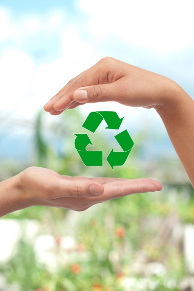 hands over recycling icon