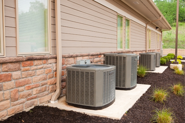 Outdoor AC units lined up outside a building