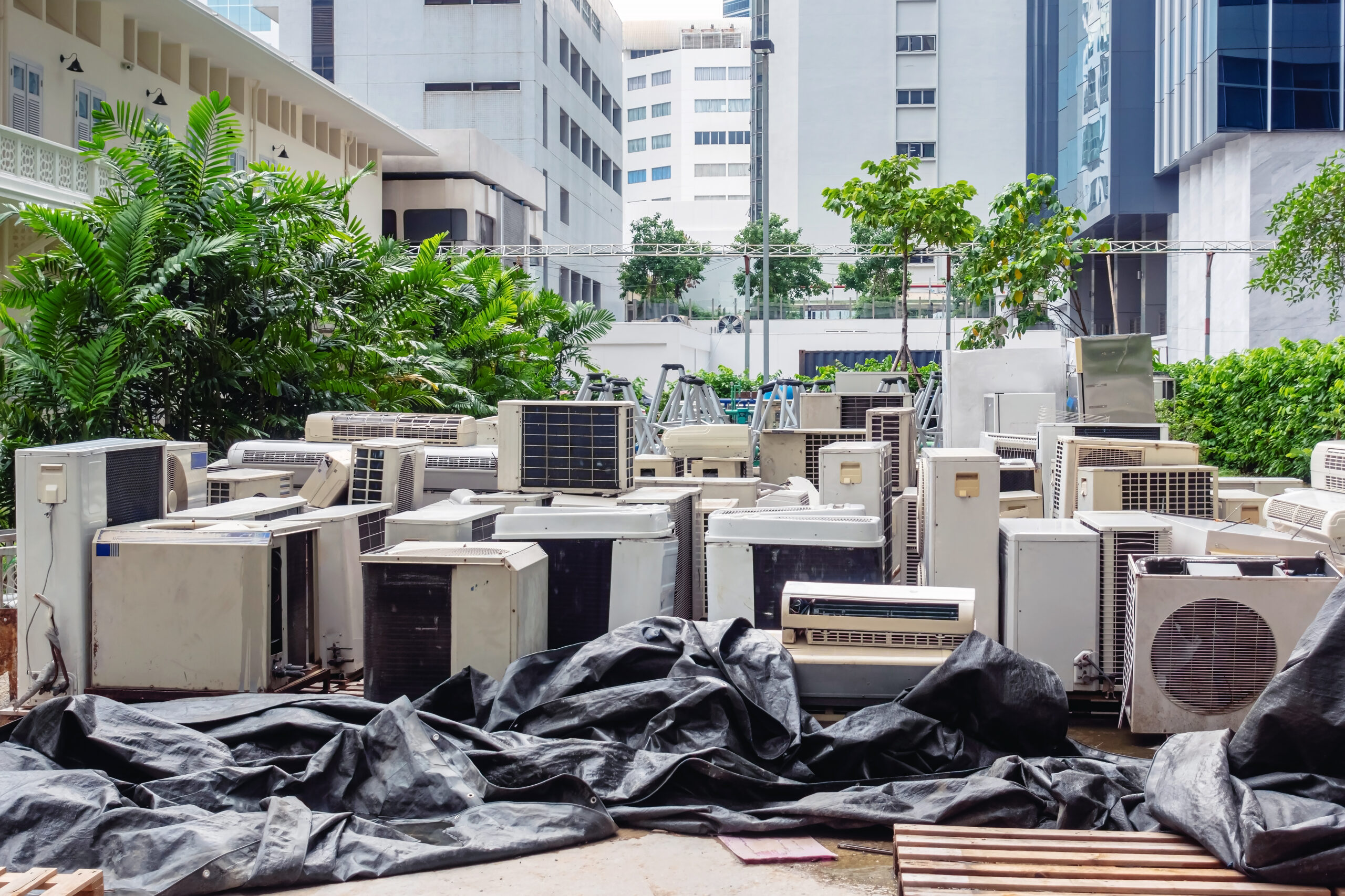 A lot of Air conditioners stacked up in a pile to disposal at recycling garbage dump. Stack of old and dirty air conditioners defective and discarded for recycling process industry. Old appliances.