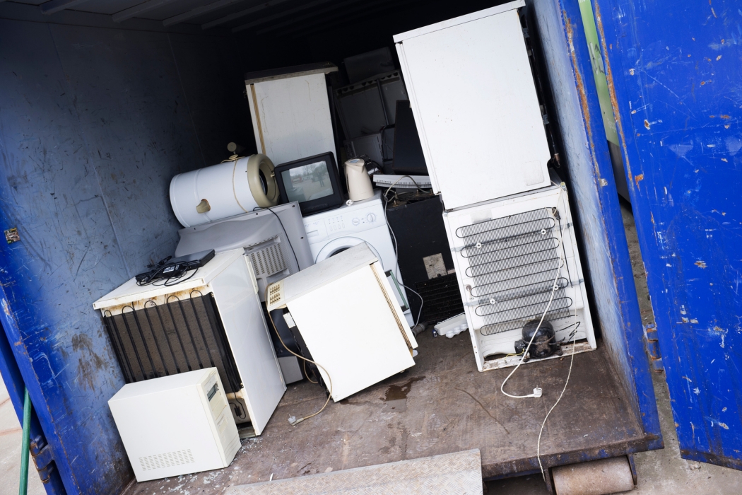 Old freezers and appliances loaded into an e-waste container