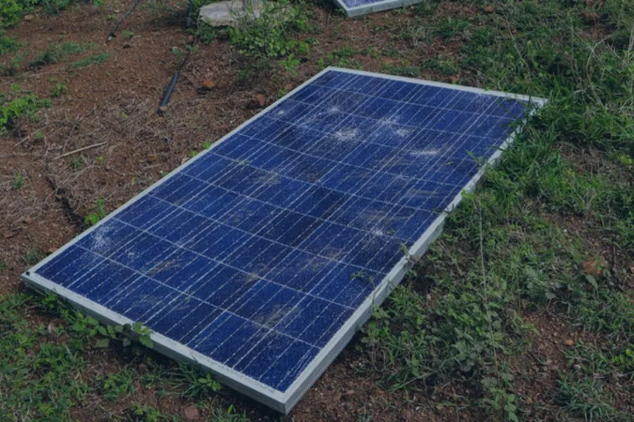broken solar panel in grass