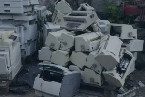 Old printers stacked for electronics recycling